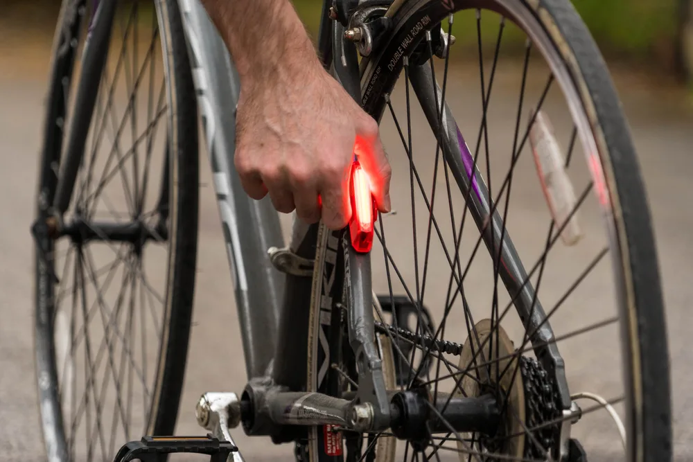 Luz traseira vermelha acesa na roda de uma bicicleta