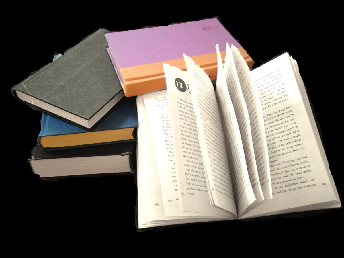 Pilha de romances encadernados com um livro aberto à frente