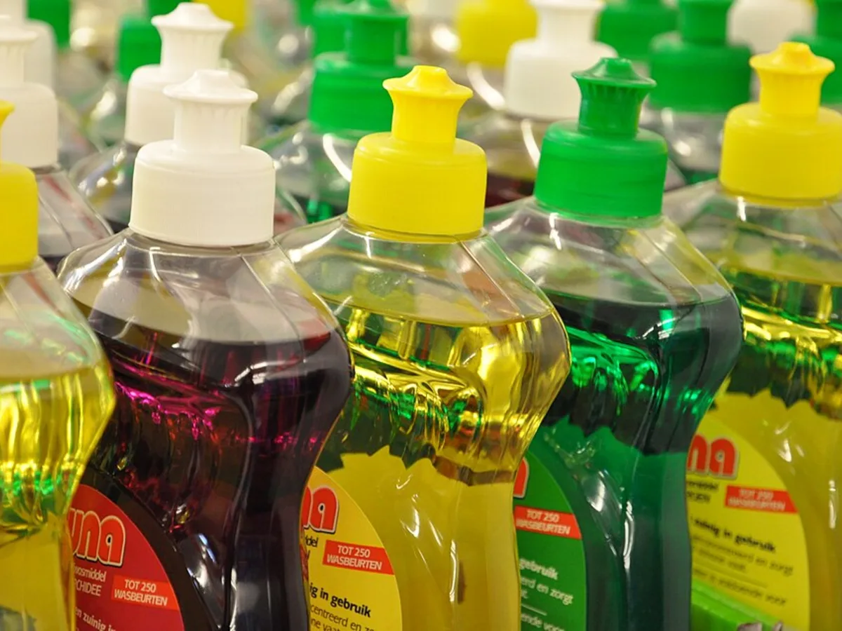 Fileiras de frascos transparentes de detergente líquido colorido